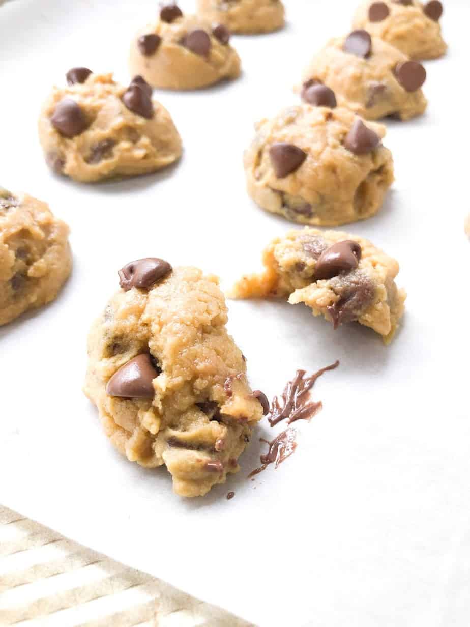 Baked pudding cookies on baking sheet with one broken in half.