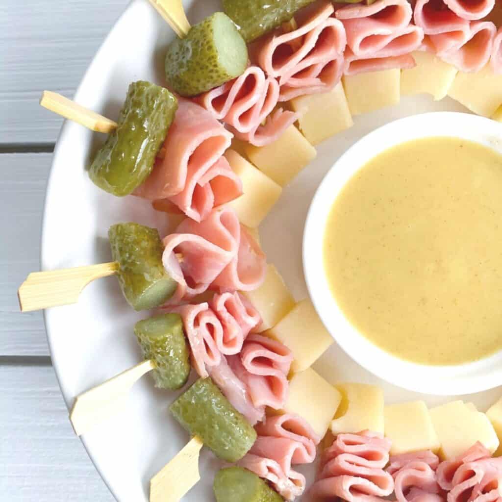 mini cubanos on a stick with cheese, pickles and ham
