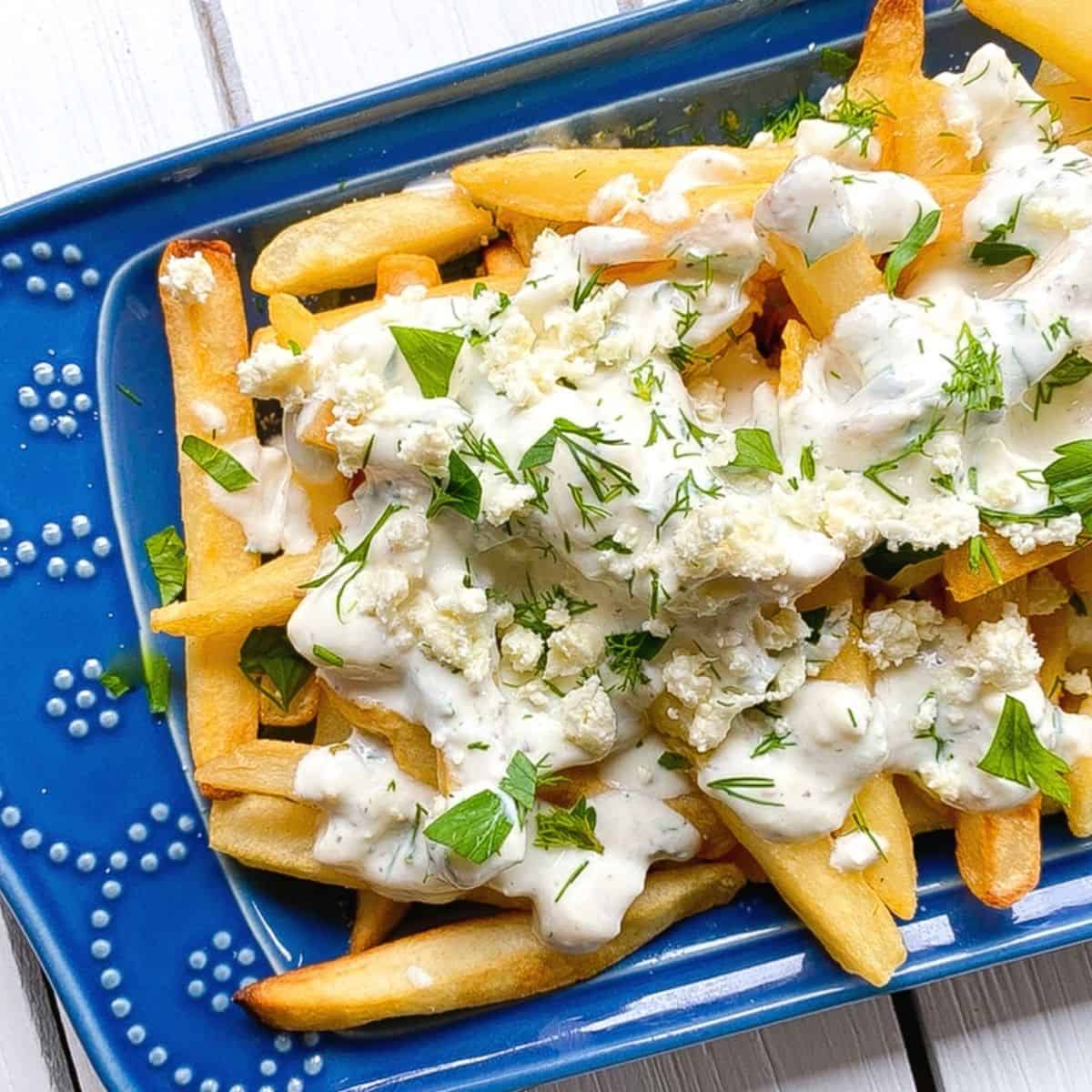 greek feta cheese fries on a blue plate