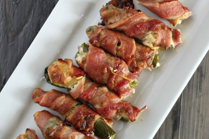 A row of chicken bacon ranch poppers on a rectangle white plate.