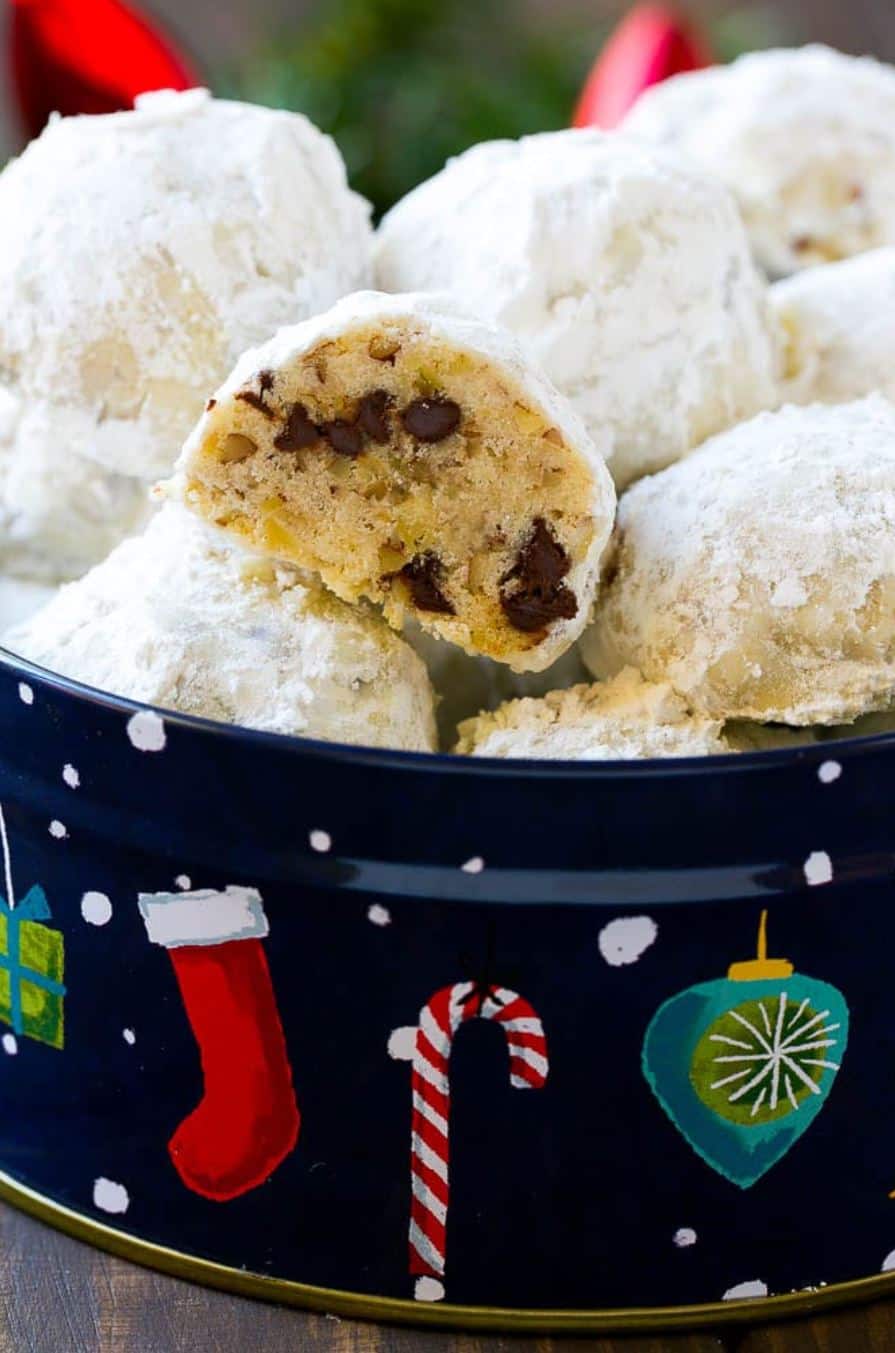 Snowball cookies with chocolate chips in a Christmas tin.