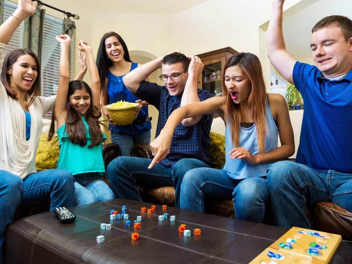 Adults sitting around a table playing a game.