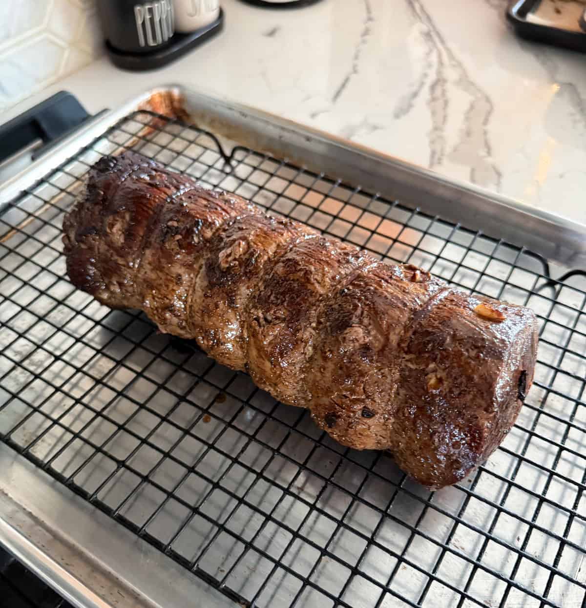 Chateaubriand roast on a wire rack before going into the oven.